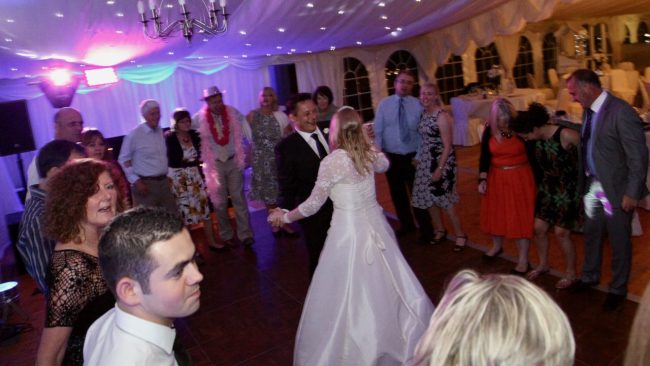 Ash and Sue dancing with all their friends and family at their Cotswolds wedding party
