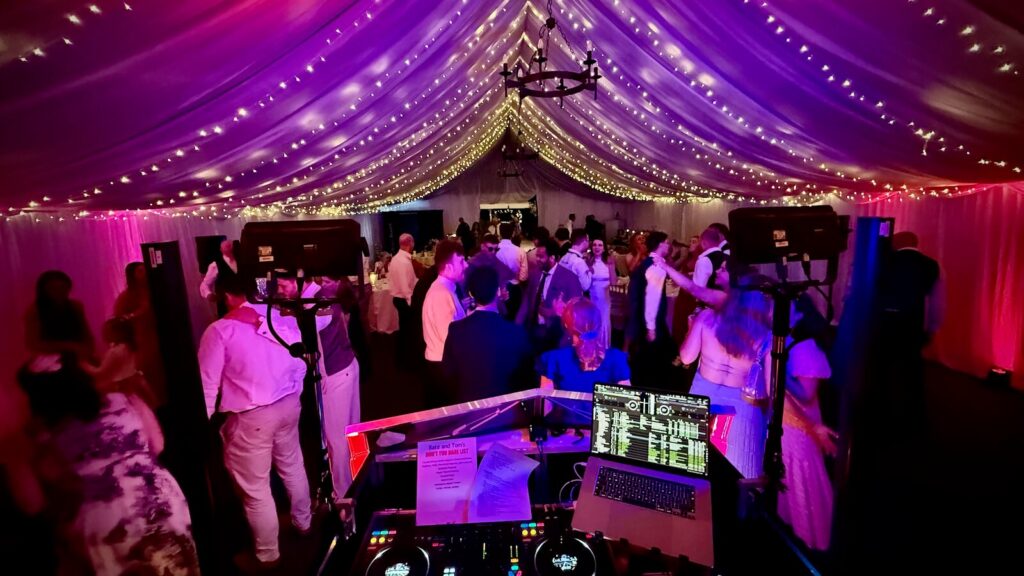 Kate and Tom dancing at their wedding party with all their guests