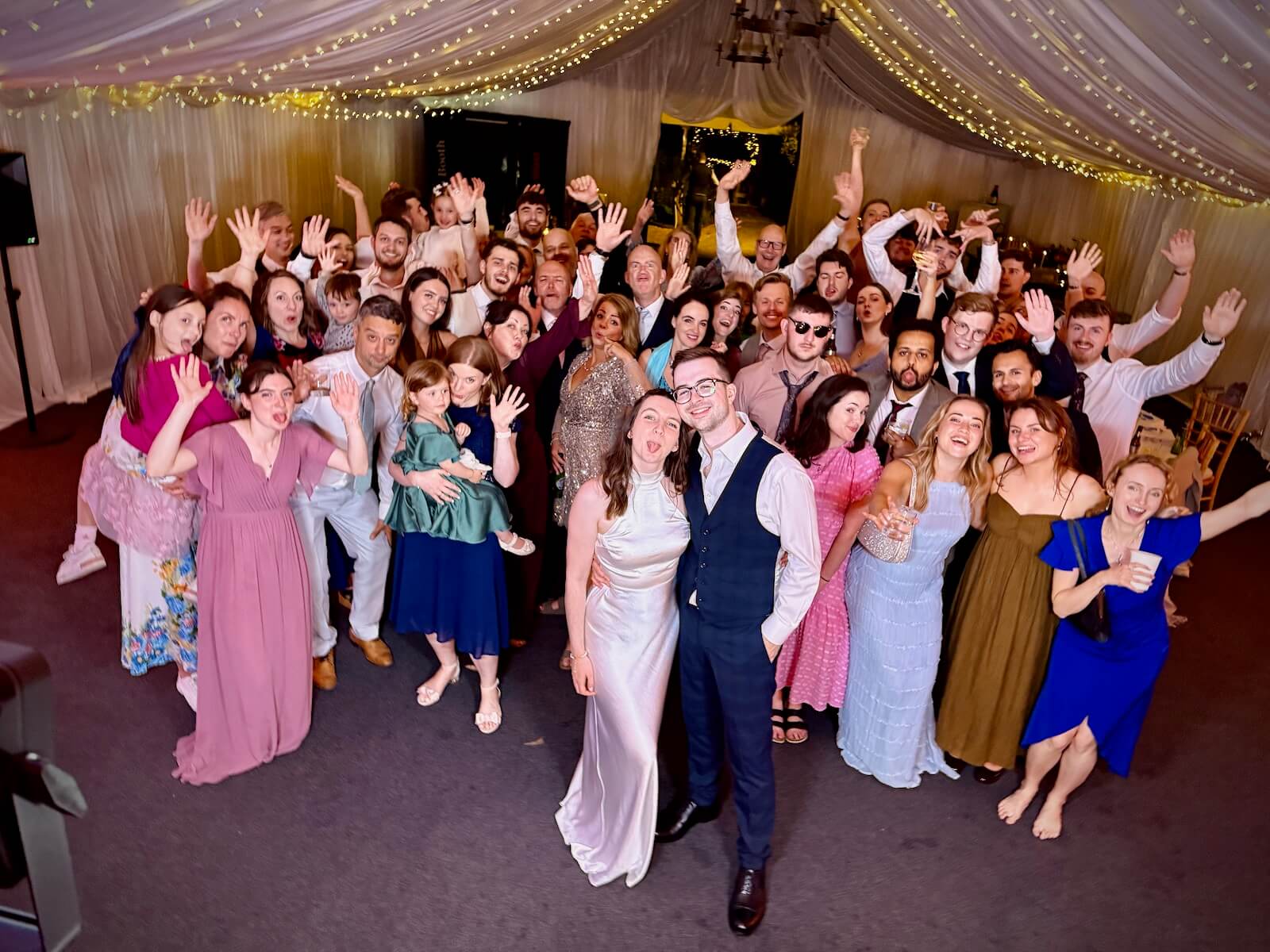 Kate and Tom at the end of their wedding party with all their guests