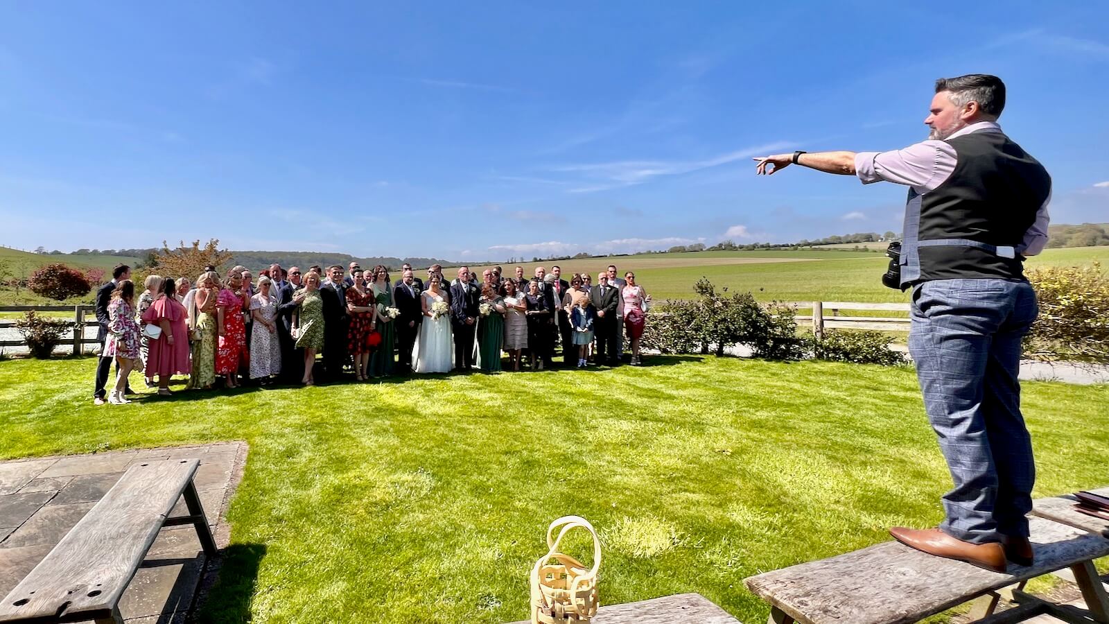 Wedding photographer Andy Hornby directing the wedding party for a perfect group photo at Long Furlong Barn