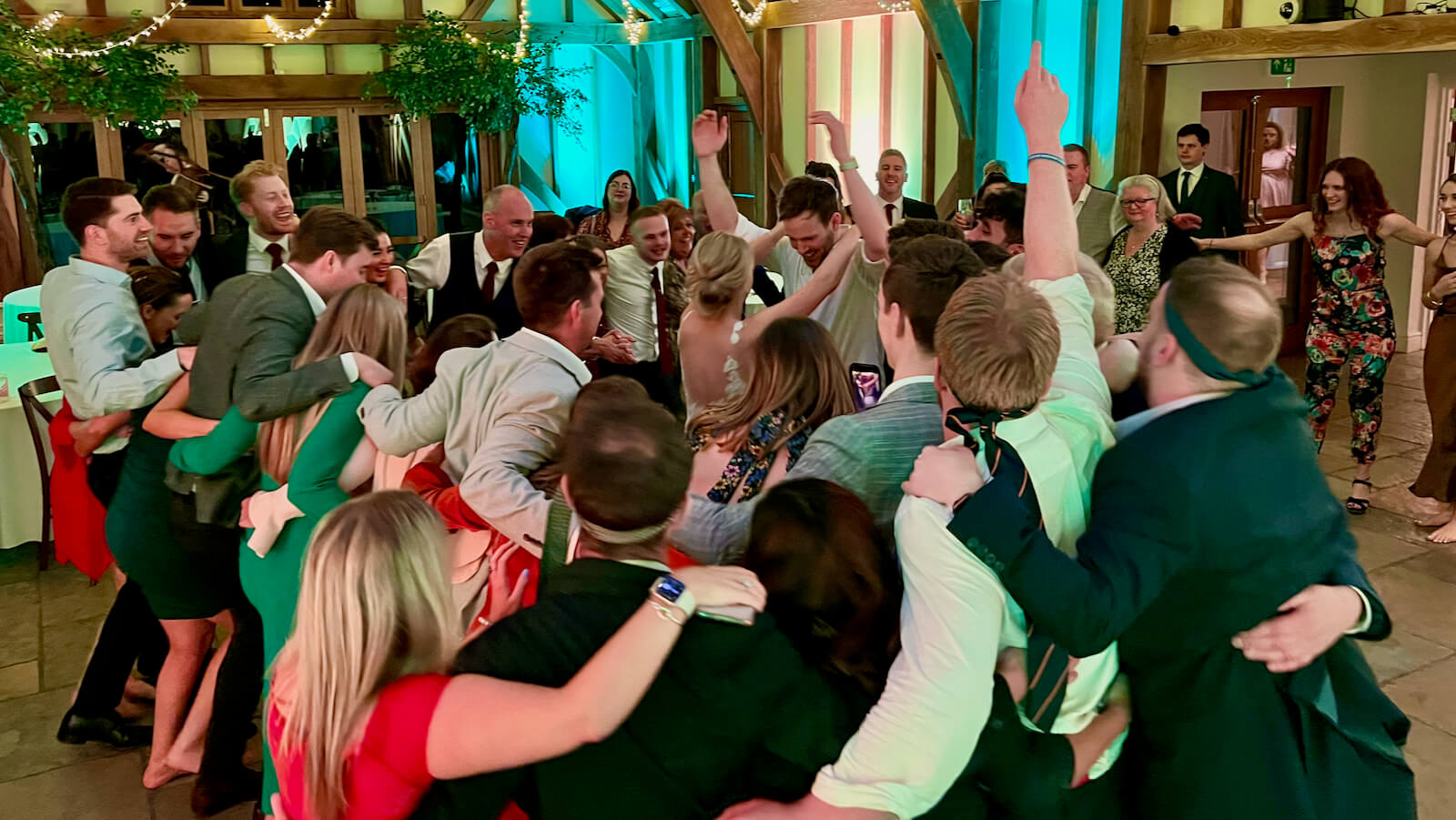 wedding at Brookfield Barn, a full dance floor of guests and family dancing with the bride and groom