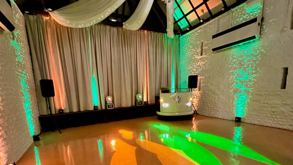 VW DJ booth at Field Place with amber and green uplighting