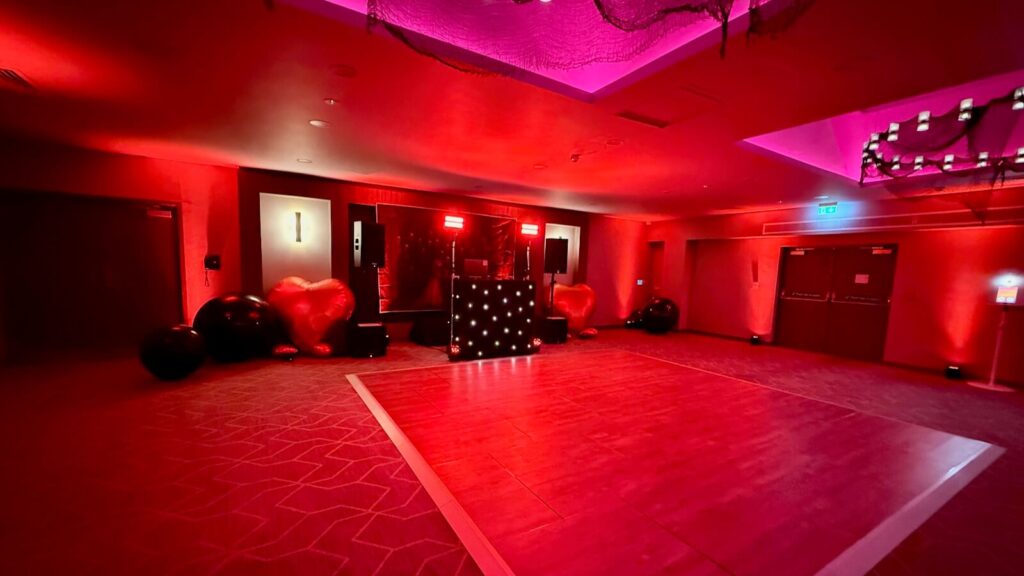 DJ Brian Mole black starlight DJ booth and uplighting setup for Halloween wedding at Holiday Inn London Gatwick Worth Hotel