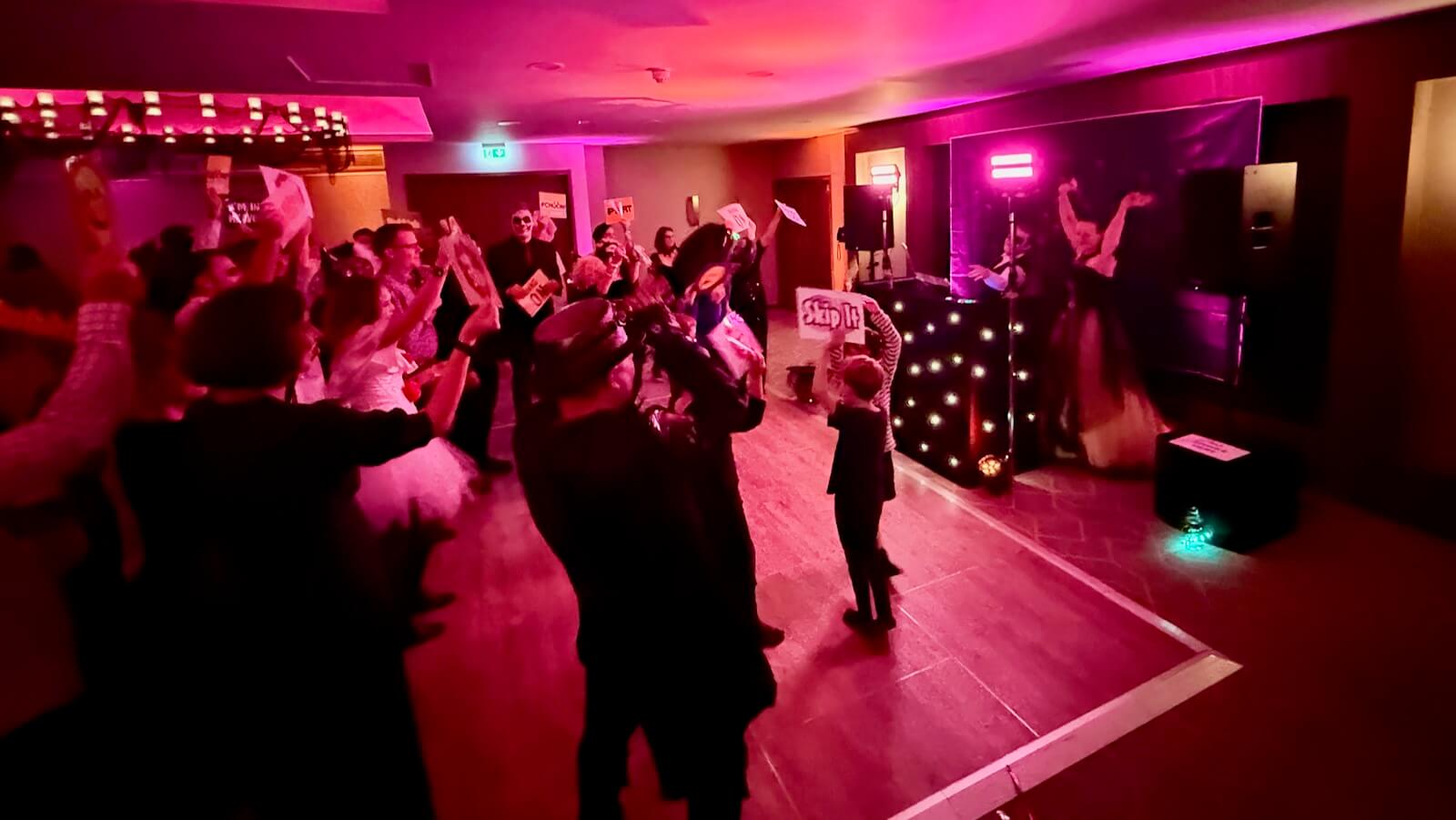Bride and groom performing a surprise DJ battle at their Halloween wedding with DJ Brian Mole at Holiday Inn London Gatwick Worth Hotel Crawley as their guests scream with fun