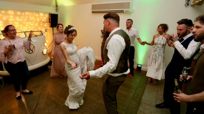 bride and groom dancing with their closest friends at a small party
